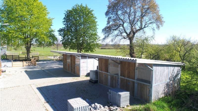 Renovated farm with horse stable and riding arena.