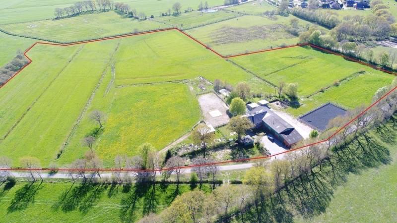 Renovated farm with horse stable and riding arena.